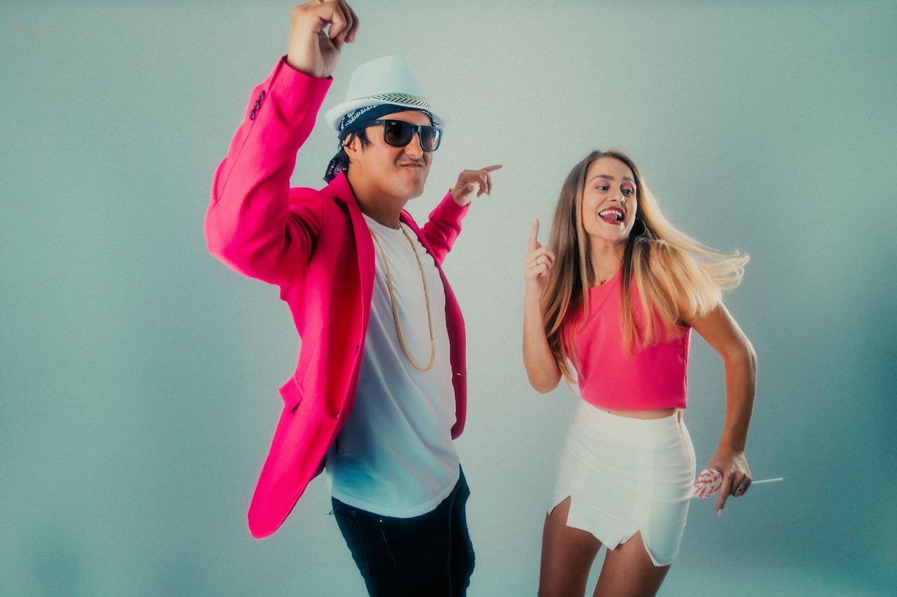 A fashionable couple enjoying a lively dance in a vibrant setting.